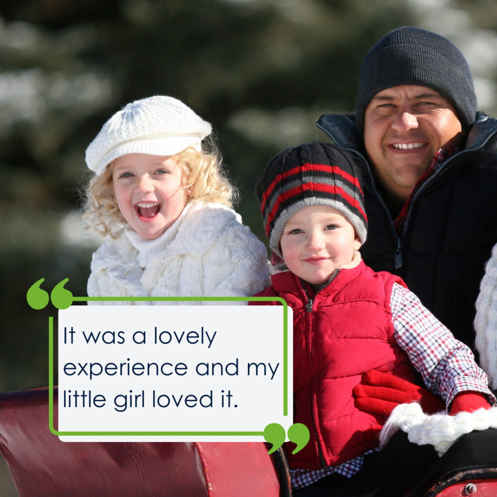 A picture of a man and his 3 children in winter clothes and hats sitting on a red sleigh, smiling at the camera. The quote on the picture reads 'It was a lovely experience and my little girl loved it.'