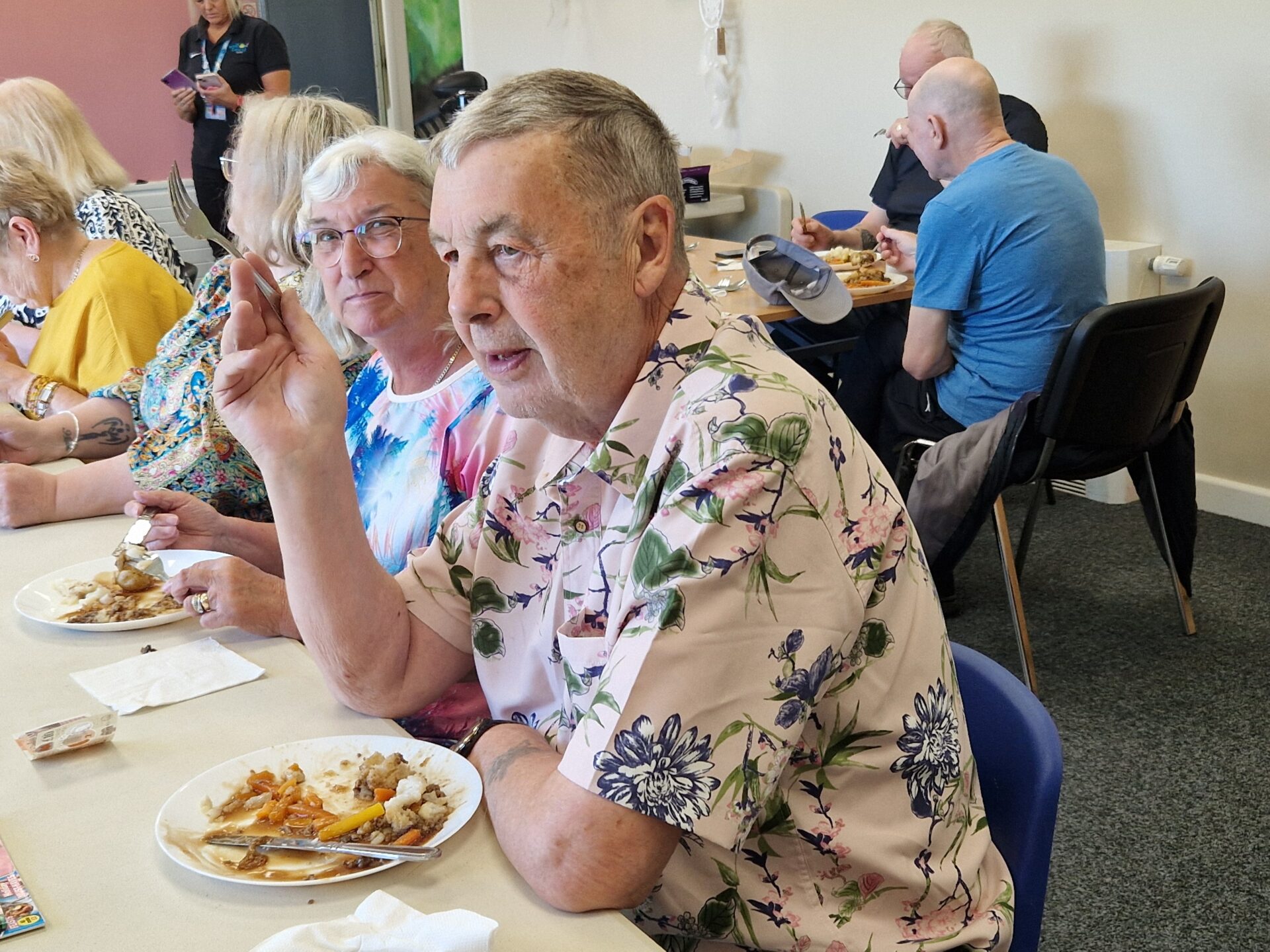 Small grant, big impact: £500 helps Shildon community centre continue providing affordable and nutritious meals for locals 2 a group of people are sat at dining tables in a community centre. They are all enjoying a nutritious meal.