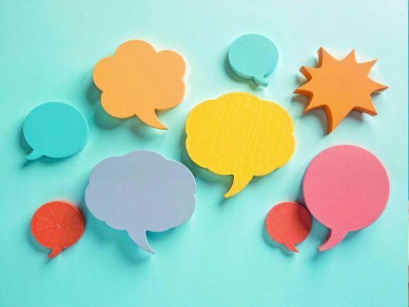 A graphic, different-shaped speech bubbles on a light blue background in different colours. Some are pointy, some are smooth, some are like clouds.
