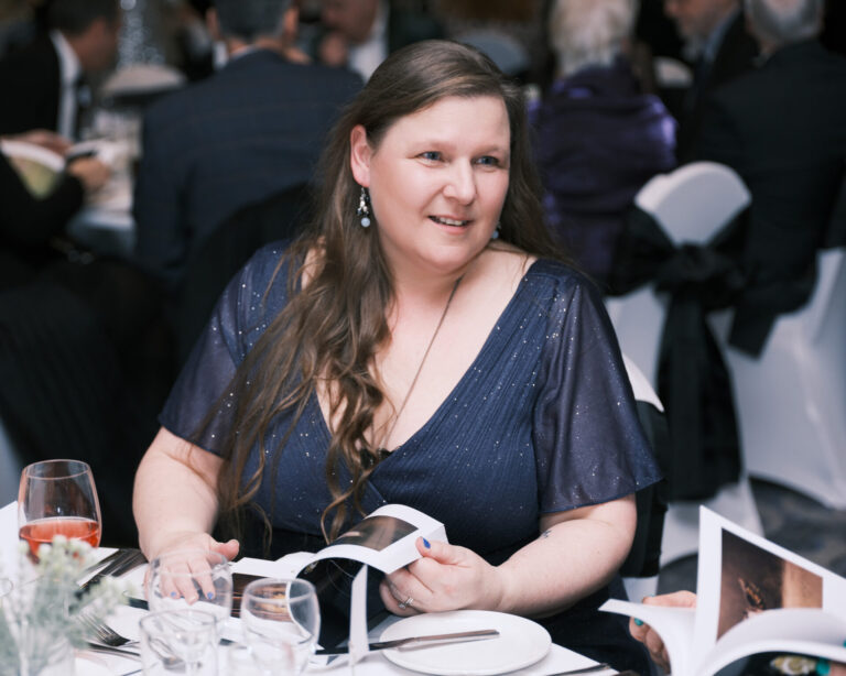 Claire dining at an event.