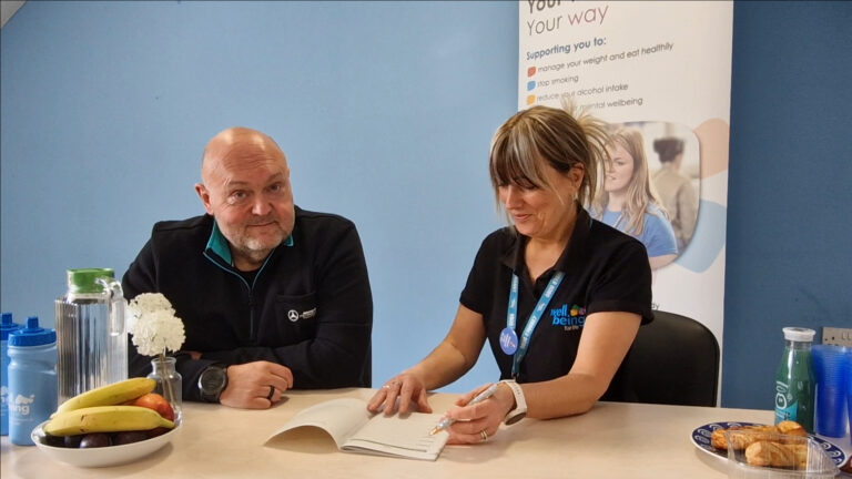 Chris and Sharon chatting and reviewing one of the Wellbeing for Life Eatwise session booklets.