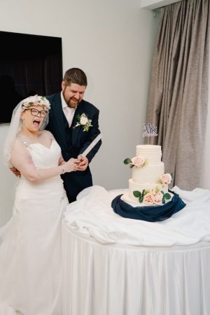 Emma and Dan cutting wedding cake