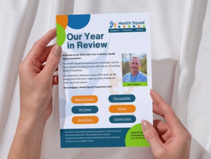 a close up of the year in review leaflet being held ready to read